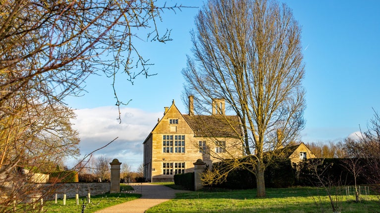 An accessible path leading up to the Manor House, with a string of lights highlighting the way.